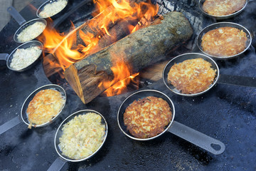Pellets in a frying pan by the fire