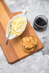 Schwarzer, deutscher Kaviar mit Blinis und Eier Hack auf Holzbrett