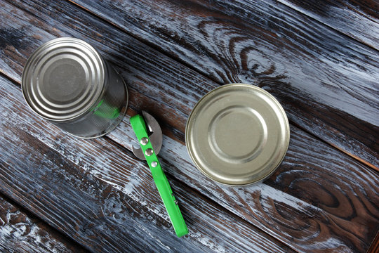 two aluminum cans on wooden background