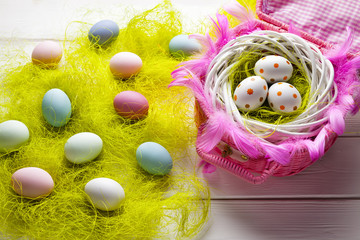 Fototapeta na wymiar Easter background - White and colored eggs on wooden background