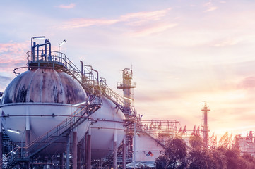 Gas storage spheres tank in oil refinery plant on sky sunset background