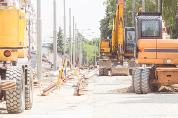 Fototapeta na wymiar Heavy public construction site with excavators and bulldozers.
