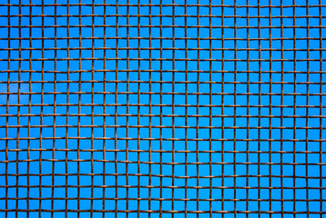 Photo of steel mesh wall on sky background