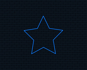 Neon light. Star sign icon. Favorite button. Navigation symbol. Glowing graphic design. Brick wall. Vector