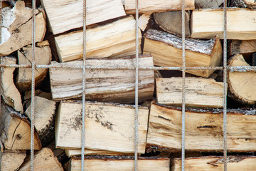 Firewood in metal containers, close up;