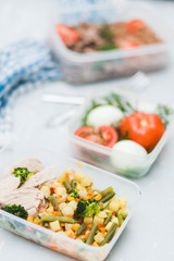 Tasty lunch in plastic containers on wooden table close up