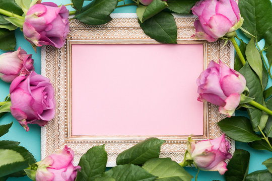 Happy Mother's Day, Women's Day, Valentine's Day or Birthday Flat Lay Background. Beautiful wooden vintage picture frame, fresh pink roses and copy space.