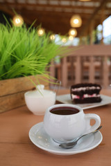 Kettle with a drink and dessert in a street cafe. Tea in the ket