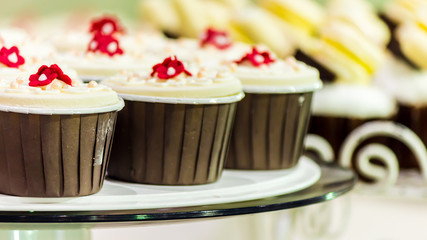 Sweet wedding cupcakes./ Sweet beauty flower and topping pastel color on wedding cake decoration.