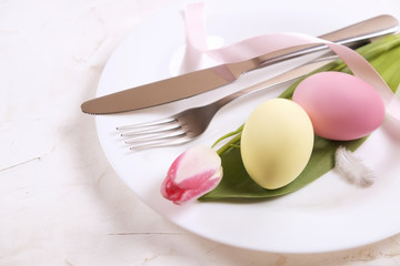 Easter laying table appointments, table setting options. Silverware, tableware items with festive...