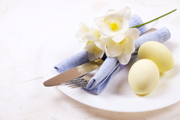 Easter laying table appointments, table setting options. Silverware, tableware items with festive decoration. Fork, knife and flowers. Happy easter holiday.