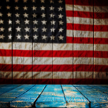 Empty wooden table over vintage USA flag background.