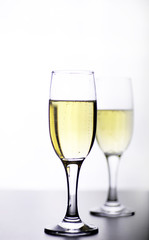 glass of white wine on a table on white background isolate