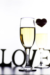 glass of white wine on a table on white background isolate