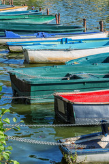 Row of old vintage colorful boats on the lake of Enghien les Bains near Paris, France