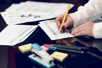 Woman fills the tax form, working with tax documents.Form 1040 Individual Income Tax return form. United States Tax forms 2017/2018.