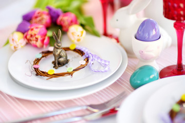 Beautiful table setting with crockery and flowers for Easter celebration