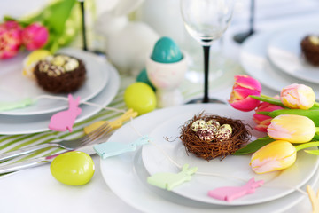 Beautiful table setting with crockery and flowers for Easter celebration