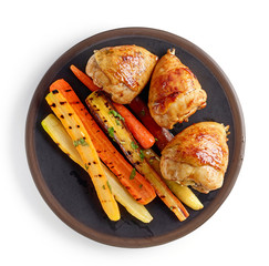 plate of grilled chicken legs and carrots