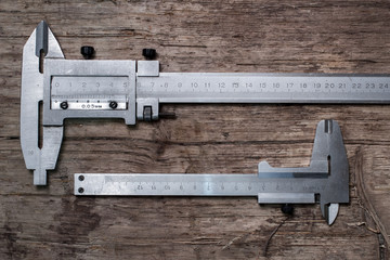 calipers on aged wood background
