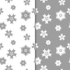 White and gray floral backgrounds. Set of seamless patterns