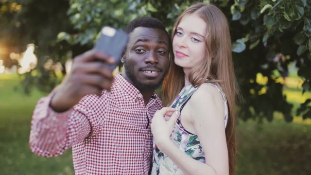 Tolerance theme. interracial couple take selfie.