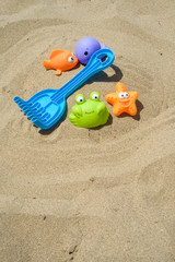 Fototapeta na wymiar Colorful toys on sand