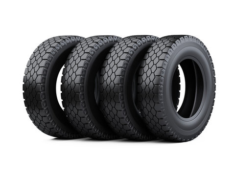 Set of four big vehicle truck tires stacked. New car wheels.