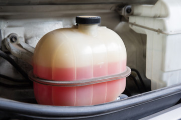 pink liquid in plastic coolant tank  for car cooling system