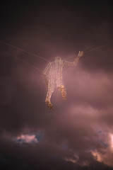Abstraction of a electricity man from a wire in front of a stormy cloudy sky.  Concept