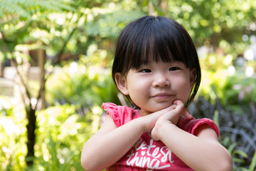 Portrait of beautiful asian child girl in outdoor park