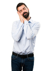 Handsome man with beard making sleep gesture