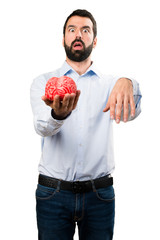 Handsome man with beard holding a brain