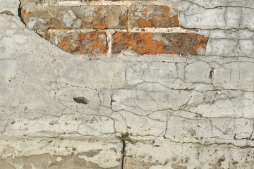 Wall background texture. white plaster in cracks. red bricks from under plaster.