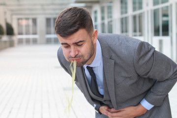 Sick businessman throwing up in the office