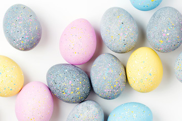 Background with pale pink, blue, yellow and gray Easter eggs. Compositions in pastel colors.  Easter concept