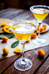 cocktail with kumquat on wooden background