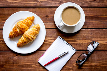 Business breakfast with coffee and croussant top view