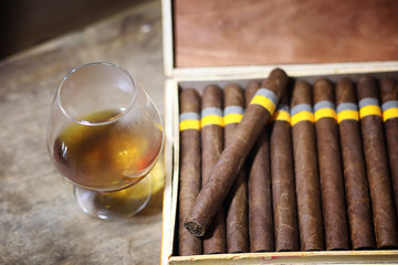Large box of Cuban cigars on a wooden table