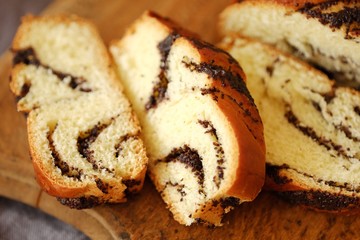 Fresh baked poppy seed roll on the table   