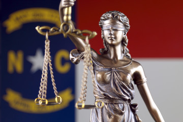 Symbol of law and justice with North Carolina Flag. Close up.