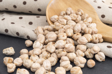 grains of chickpeas falling from a spoon