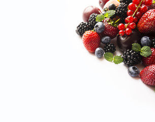 Mix berries on a white background. Ripe blueberries, blackberries, red currants, strawberries and black currant. Berries and fruits with copy space for text. Background berries.