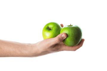 Man holding two green apples in his hand. Isolated on white background.