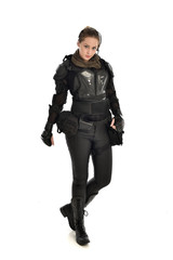 Fototapeta premium full length portrait of female soldier wearing black tactical armour, isolated on white studio background.