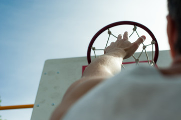 hand and basketball hoop up
