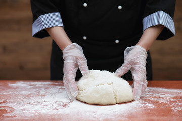 the cook makes flour for baking on the table