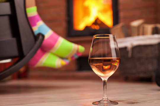 Woman with funny socks relaxing with a glass of wine