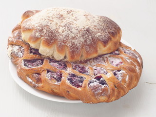 Freshly baked pastries assorted. Homemade buns on white plate. Selective focus on the front. 