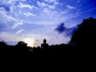 sunset in Thai forest, buddha statue